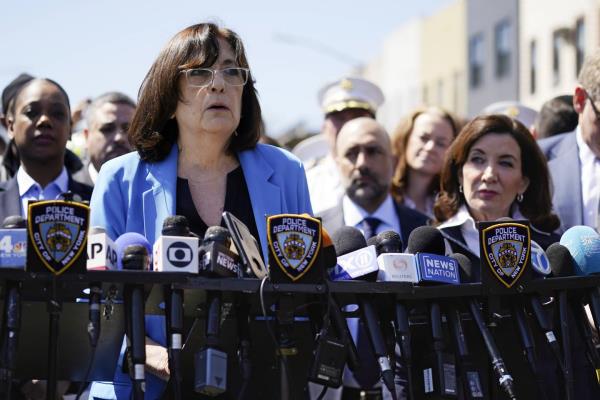 First Deputy Mayor Lorraine Grillo, left, speaks at a news conference, as New York Gov. Kathy Hochul listens, right, in April 2022. 

