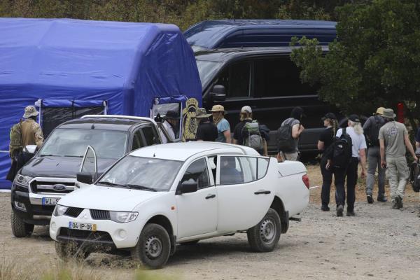 Police search teams arrive back to an operation tent near Barragem do Arade, Portugal, May 23, 2023.