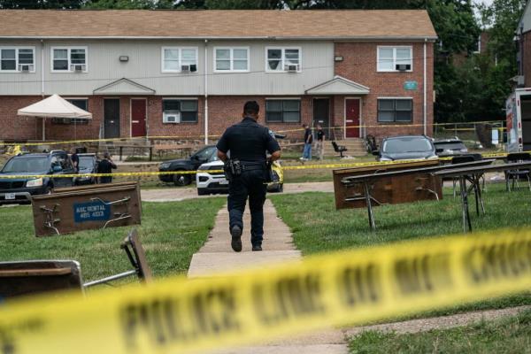 Baltimore Police investigate the site of a mass shooting in the Brooklyn Homes neighborhood on July 2, 2023 in Baltimore, Maryland. At least two people were killed and 28 others were wounded  during the shooting at a block party on Saturday night.