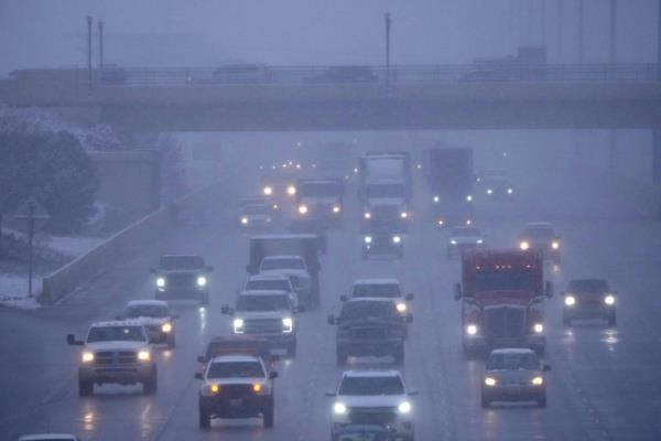 Cars drive north on I-15 after an overnight storm in Lehi, Utah on December 13, 2022.