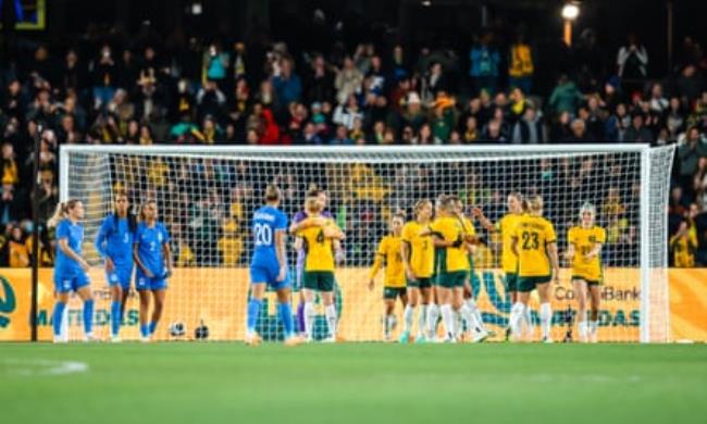Australia players huddle and high five after beating France in the pre-tournament friendly