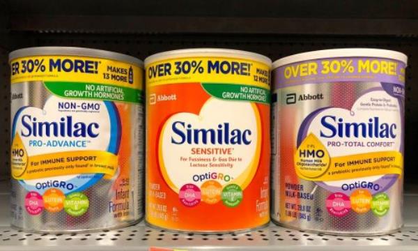 Grocery store shelf with co<em></em>ntainers of Similac brand powdered formula. Infant formula, is a manufactured food designed and marketed for feeding babies under 1 yr old.