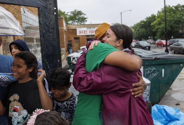Giovanni Gonzalez, of Venezuela, hugs a Rogers Elementary School teacher shortly before being transferred from the High Ridge YMCA migrant shelter to Daley College on June 13, 2023.